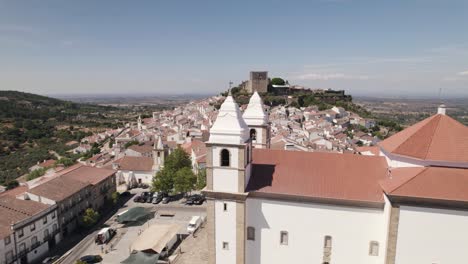 church of santa maria da devesa and castle ruins in background, castelo de vide in portugal