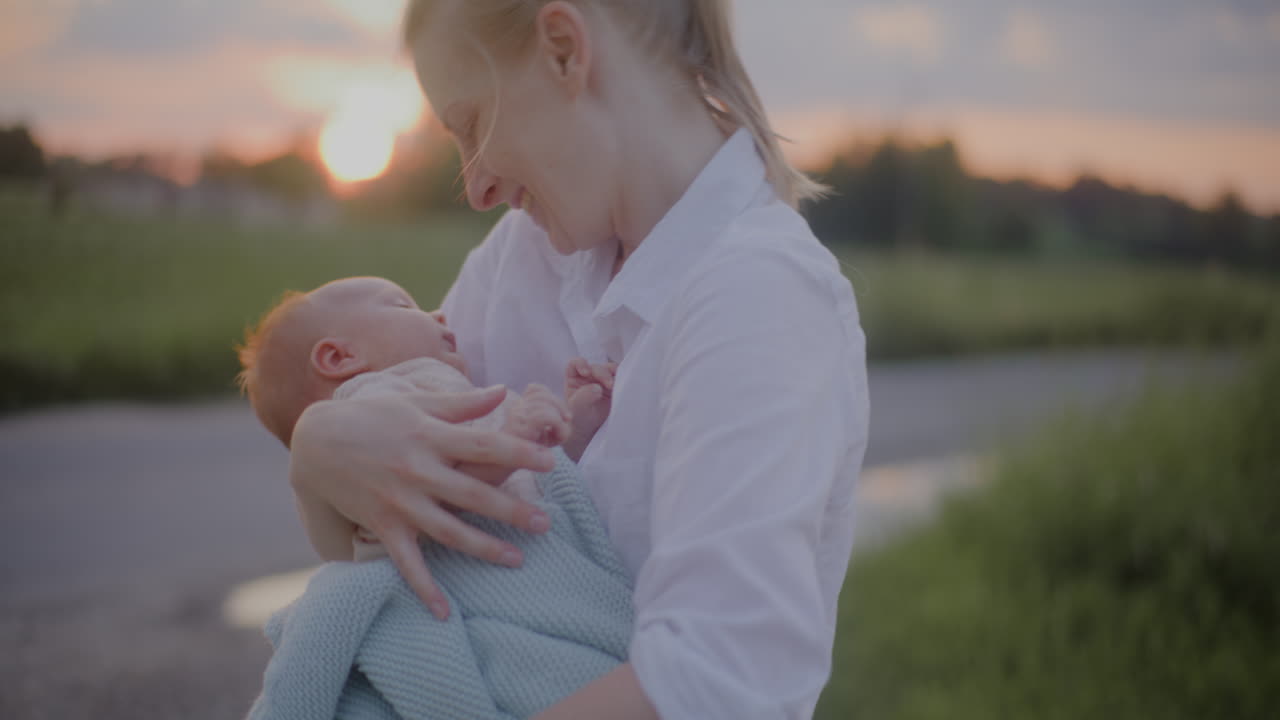 Mother Hugging Baby at Sunset Clouds