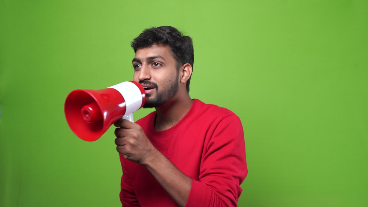 Indian young crazy man shouting on megaphone | Premium Stock Video Footage