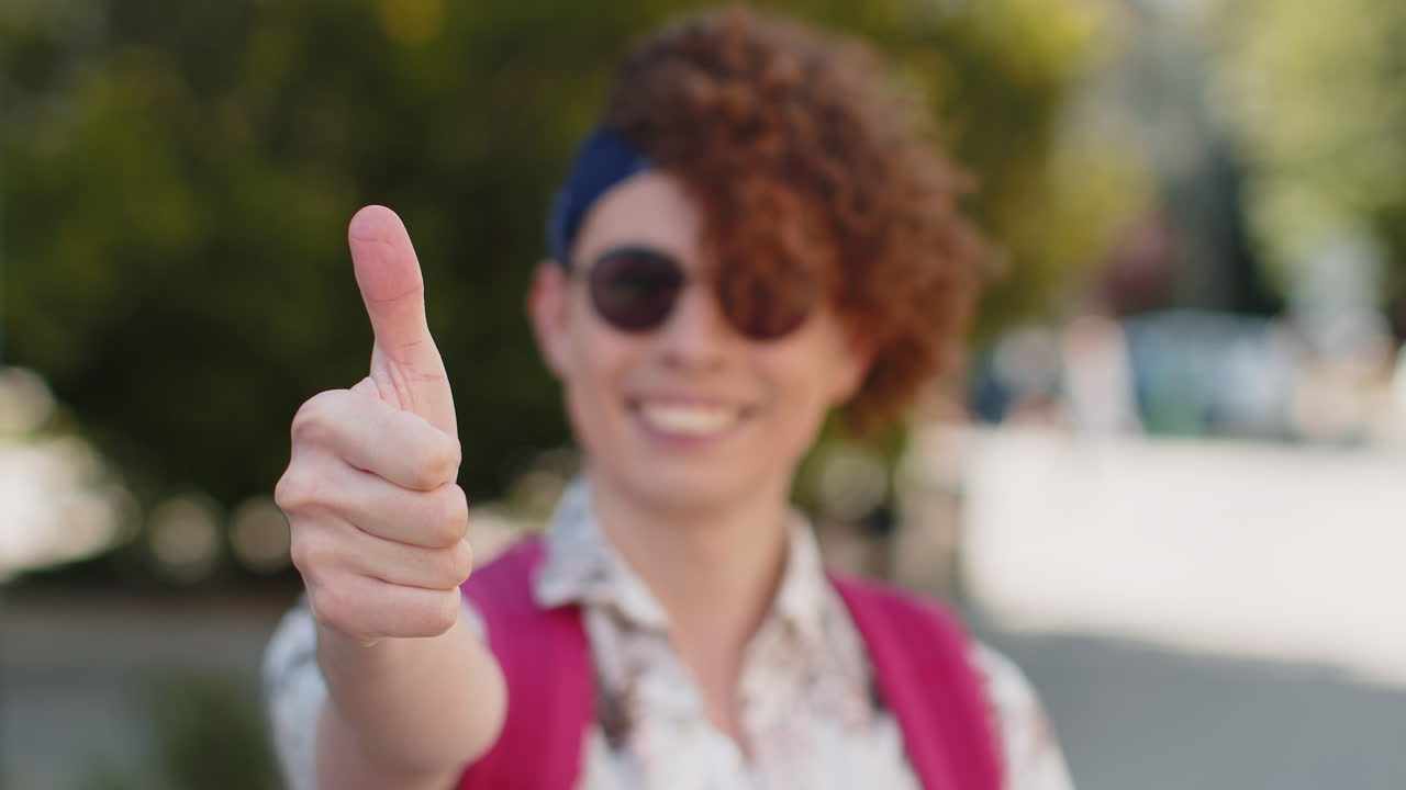 Happy young man tourist showing thumbs up like sign positive something good positive feedback
