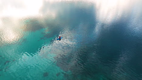 aerial view of man kayaking on lake on early morning in moso island, vanuatu