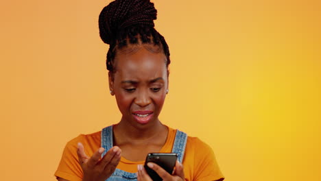 Confused,-black-woman-and-phone-spam-in-a-studio