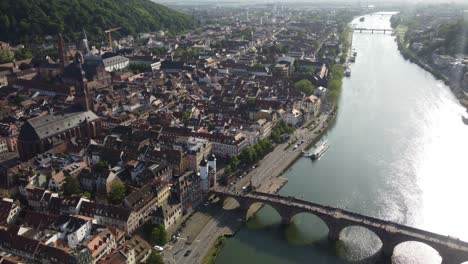 Heidelberg-city-aerial,-Pedestrian-Tourists-sightseeing-Theodor-footbridge-and-church-of-the-holy-spirit-on-a-sunny-summer-day,-Germany