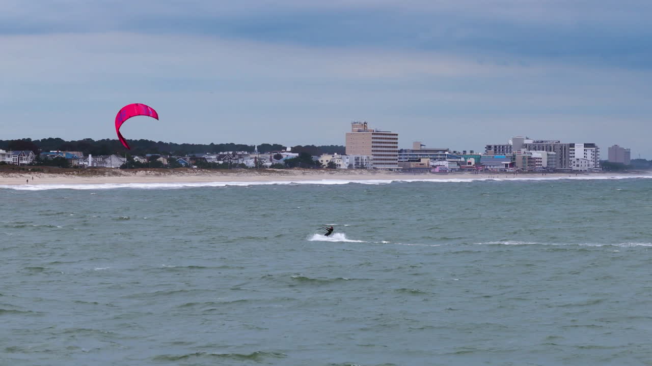 Telephoto drone shot of a windsurfer on lake Michigan, cloudy day in Delaware
