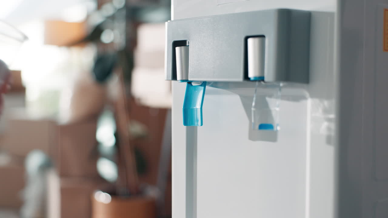 Man filling cup from water cooler