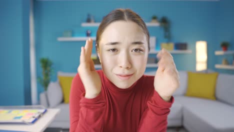 paranoid asian young woman looking at camera.