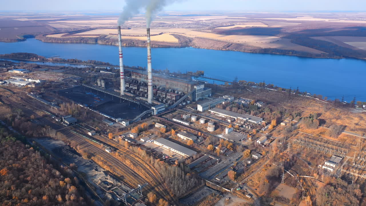 Industrial factory pollutes sky. A large power plant works on the coast