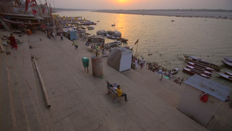 reveal shot of the ganges riverbank at sunset