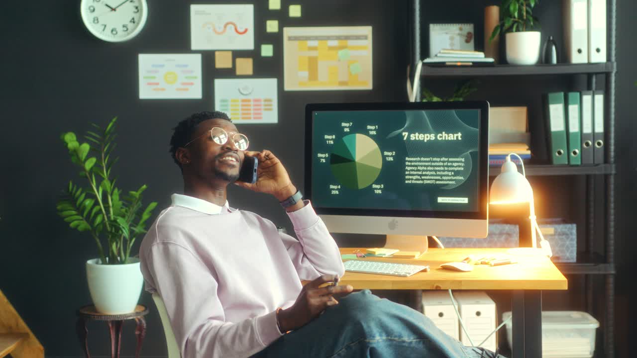 Young African American Businessman Talking on Phone in Office
