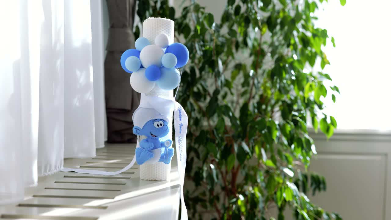 White candle decorated for orthodox christening. Orthodox religion. Christening object for church.