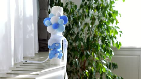 white candle decorated for orthodox christening. orthodox religion. christening object for church.