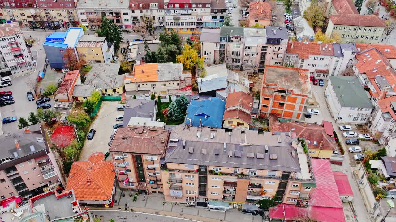 Colorful rooftops and streets of Pristina shown in crisp autumn urban overview