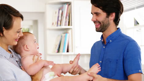 happy parents playing with their baby