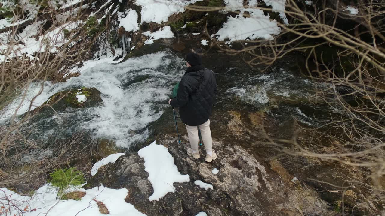 Winter Hiking in a Mountain Stream