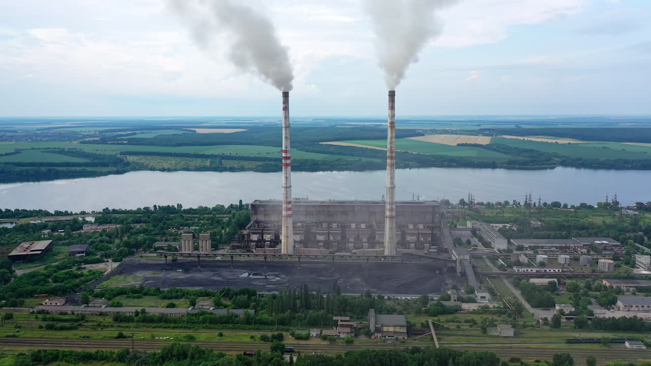 Huge factory producing electricity. Aerial Shot of polluting coal fired power reactors.