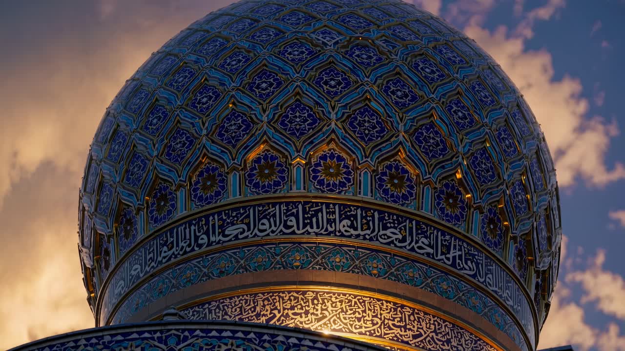 Low-angle video capture of a mosque's ornate dome at sunset, highlighting intricate patterns
