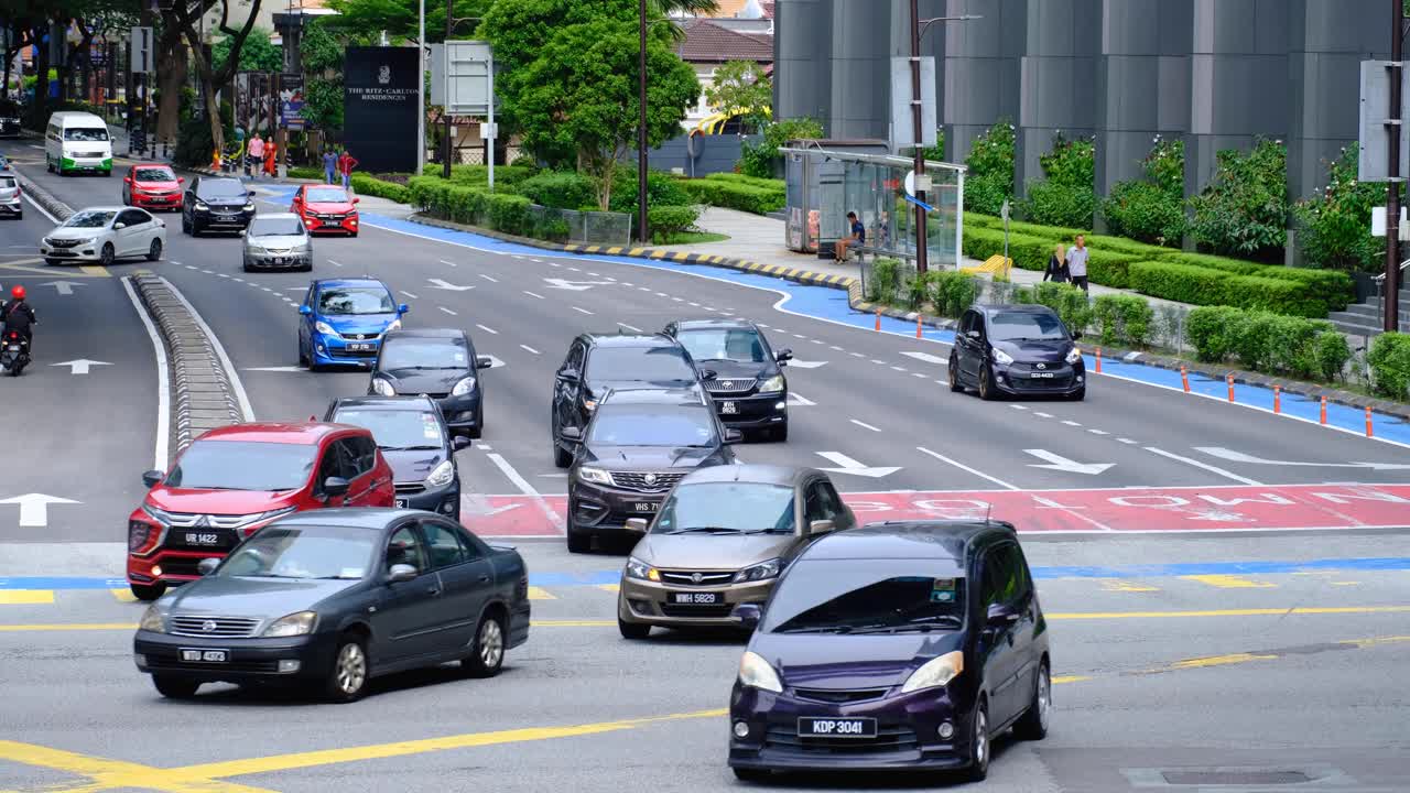 Close up of free flowing car traffic on busy 5 lane highway road in capital city of Kuala Lumpur Malaysia