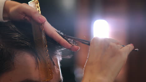 un peluquero hábil cortando el cabello masculino.