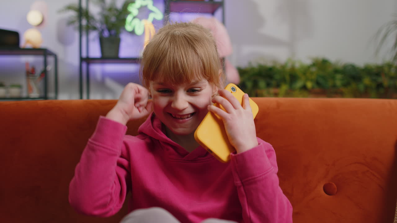 Child kid girl use smartphone playing great big surprise good news celebrate online game win