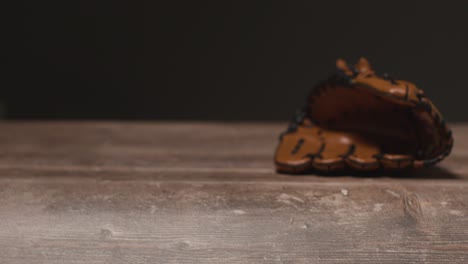 close up studio baseball still life with catchers mitt on wooden floor