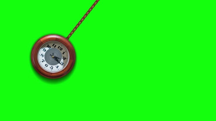 Clock dangles on the chain on the green screen