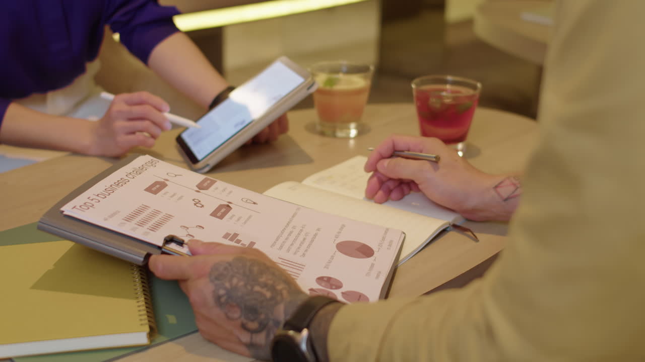 Businesspeople Discussing Work in Lounge Area with Drinks