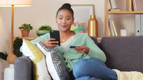 woman making an online payment with a phone