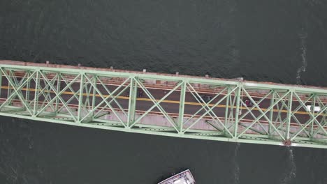 an aerial view of the fire island inlet bridge during a cloudy morning over calm waters