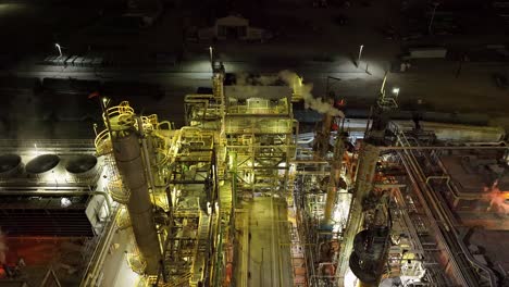 refinery at night in north salt lake utah - aerial tilt down