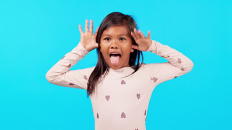 funny face, tongue out and girl child in studio
