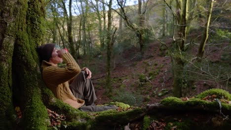 traveling woman with cup of coffee in woods