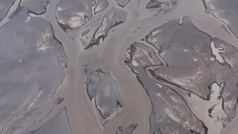 Río-De-Agua-De-Deshielo-Glacial-En-Islandia-Mezclado-Con-Minerales-Naturales,-Aéreo