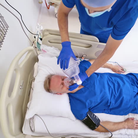 view from above on a male patient lying without signs of life. doctor gives resuscitation to a man in clinic. emergency concept.