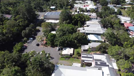 4k aerial drone shot of a small mountain village surrounded by a rainforest in north queensland, australia