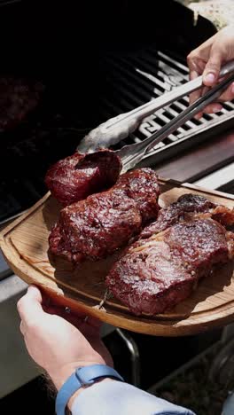 grilled steaks on a wooden cutting board