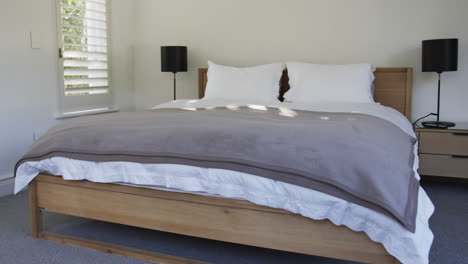 close up of bed and bedside cabinets in bedroom, slow motion