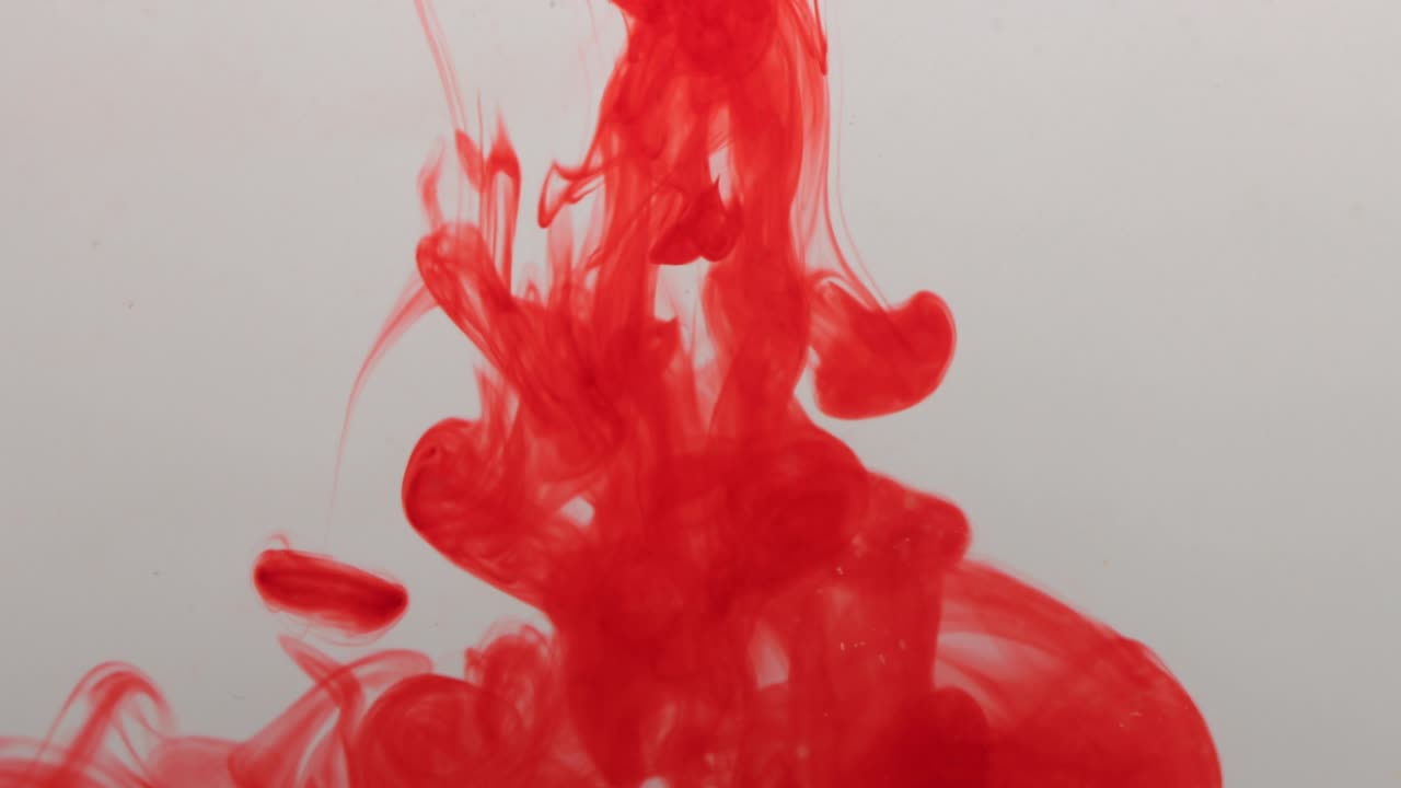 red Color paint drops in water , drop of red Ink color falling on water Colorful ink , 4K footage,