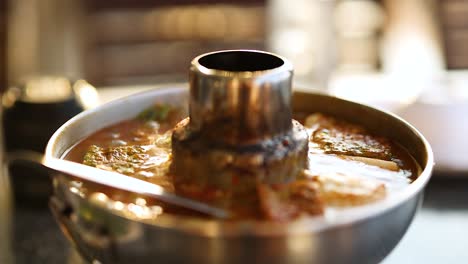 bubbling soup with catfish and eggs