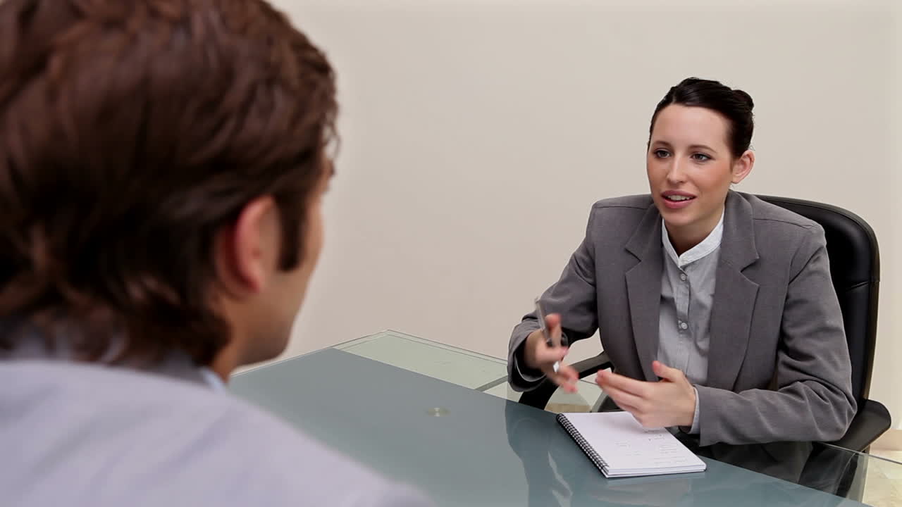 Young woman interviewing a man