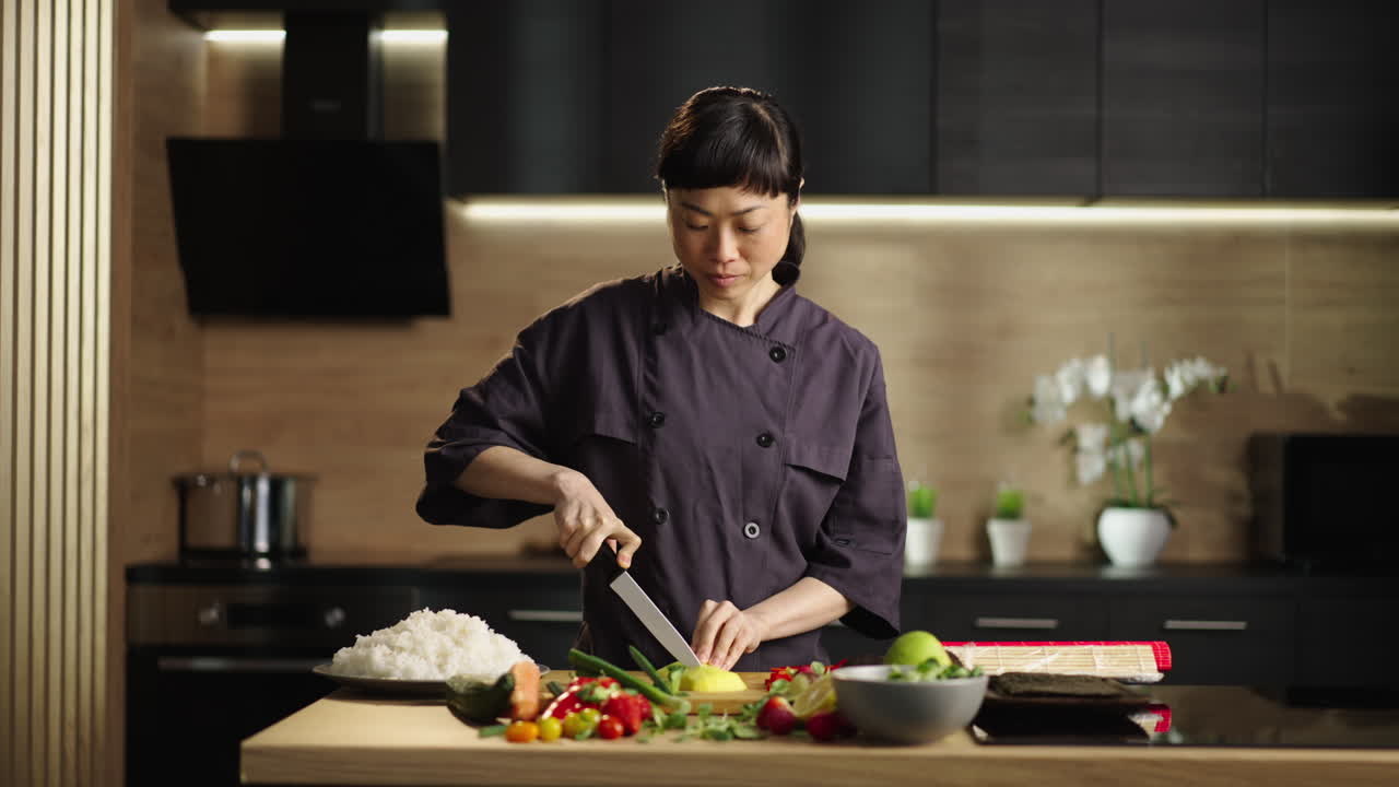 Woman preparing sushi in the kitchen
