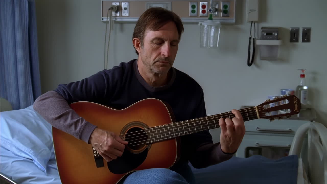 Man playing guitar in a hospital room
