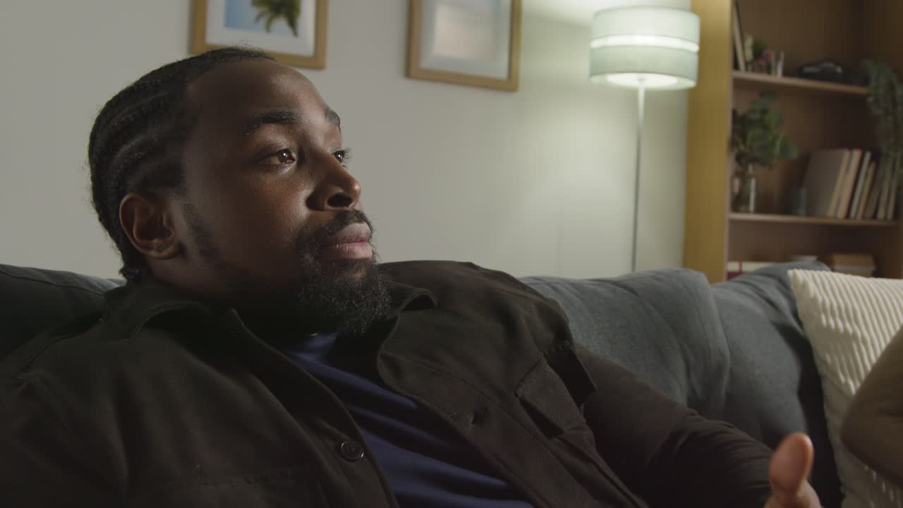 Couple At Home Sitting On Sofa In Lounge Having Breaking Up Argument 5