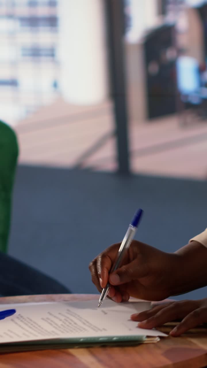 Donne d'affari che firmano un contratto e si stringono la mano in ufficio