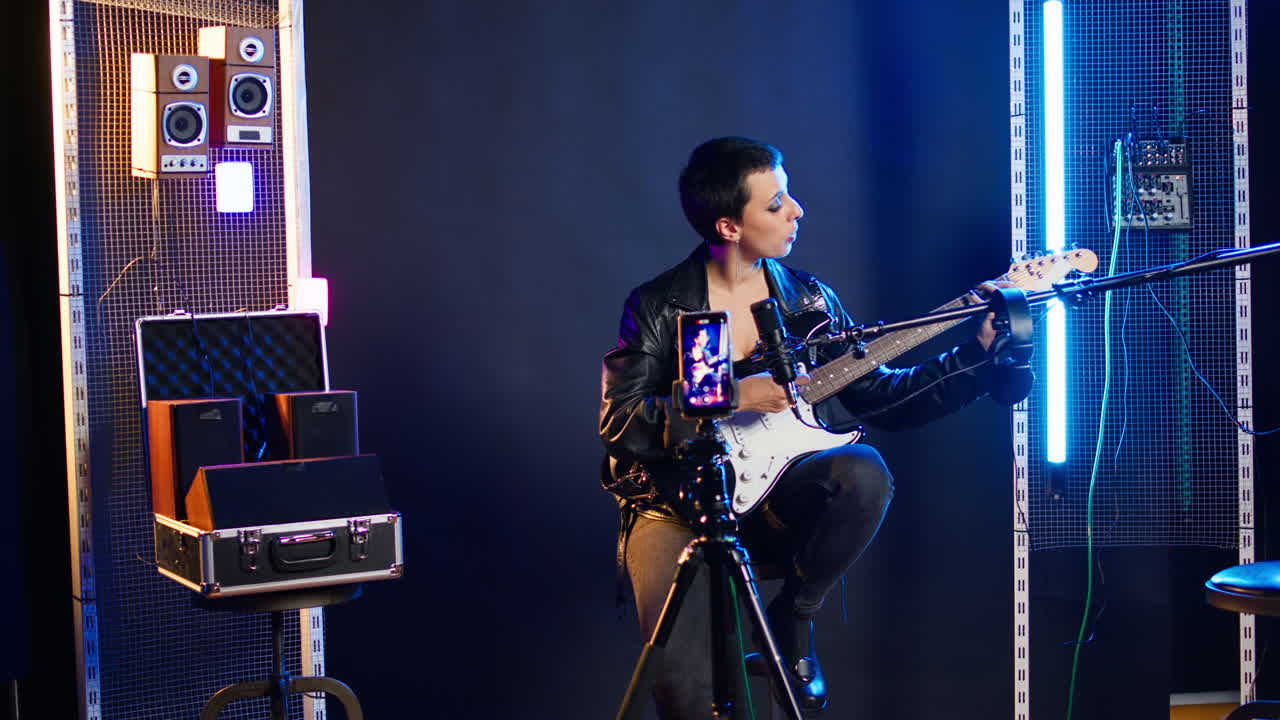 Musician performing with guitar in studio