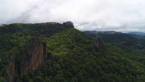 Aerial-drone-sidewards-slide-of-rocks-forming-out-of-the-forrest