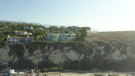 aerial shot of houses above the beach mountain