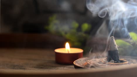 incense cone and candles on tray with teapot