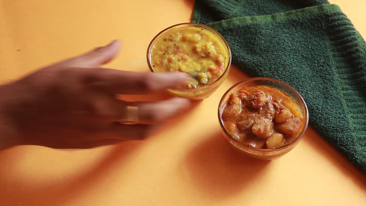 rotation Chole Bhature or Chick pea curry and Fried Puri served in terracotta crockery over yellow background