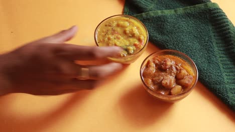 rotation chole bhature or chick pea curry and fried puri served in terracotta crockery over yellow background