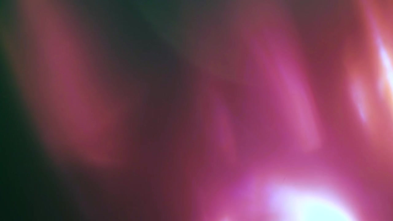 Abstract Pink and Purple Light Leaks Over Dark Background
